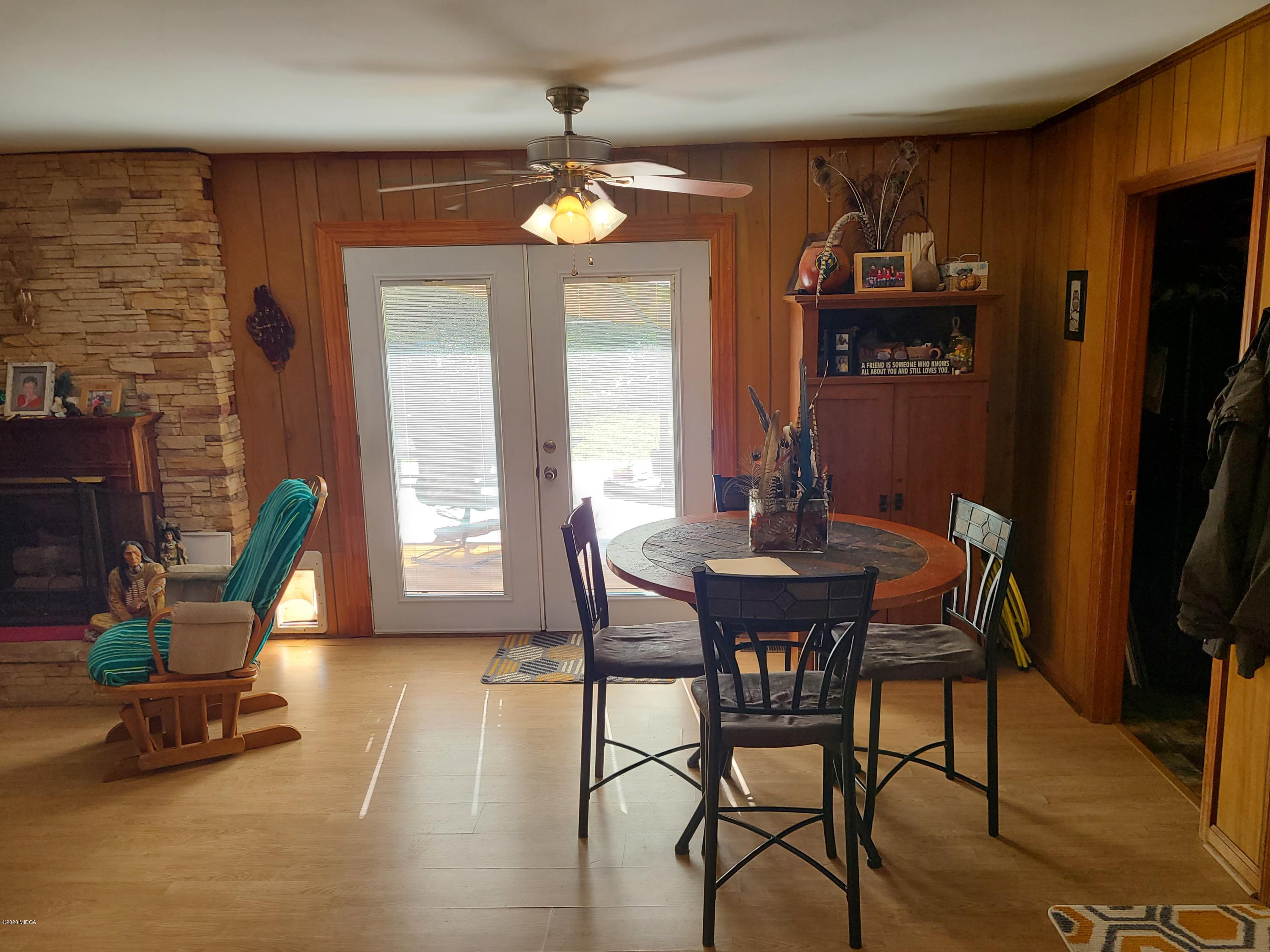 1172 Cumslo Road Macon, GA 31211 - Photo 24 of 33 a view of a dining room with furniture a chandelier and wooden floor
