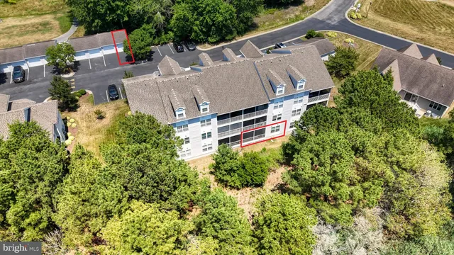 an aerial view of residential house with outdoor space and trees all around