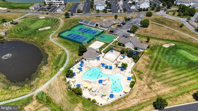 an aerial view of a swimming pool a yard and mountain view in back