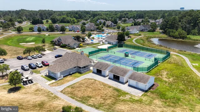swimming pool view with couple of cars parked in it