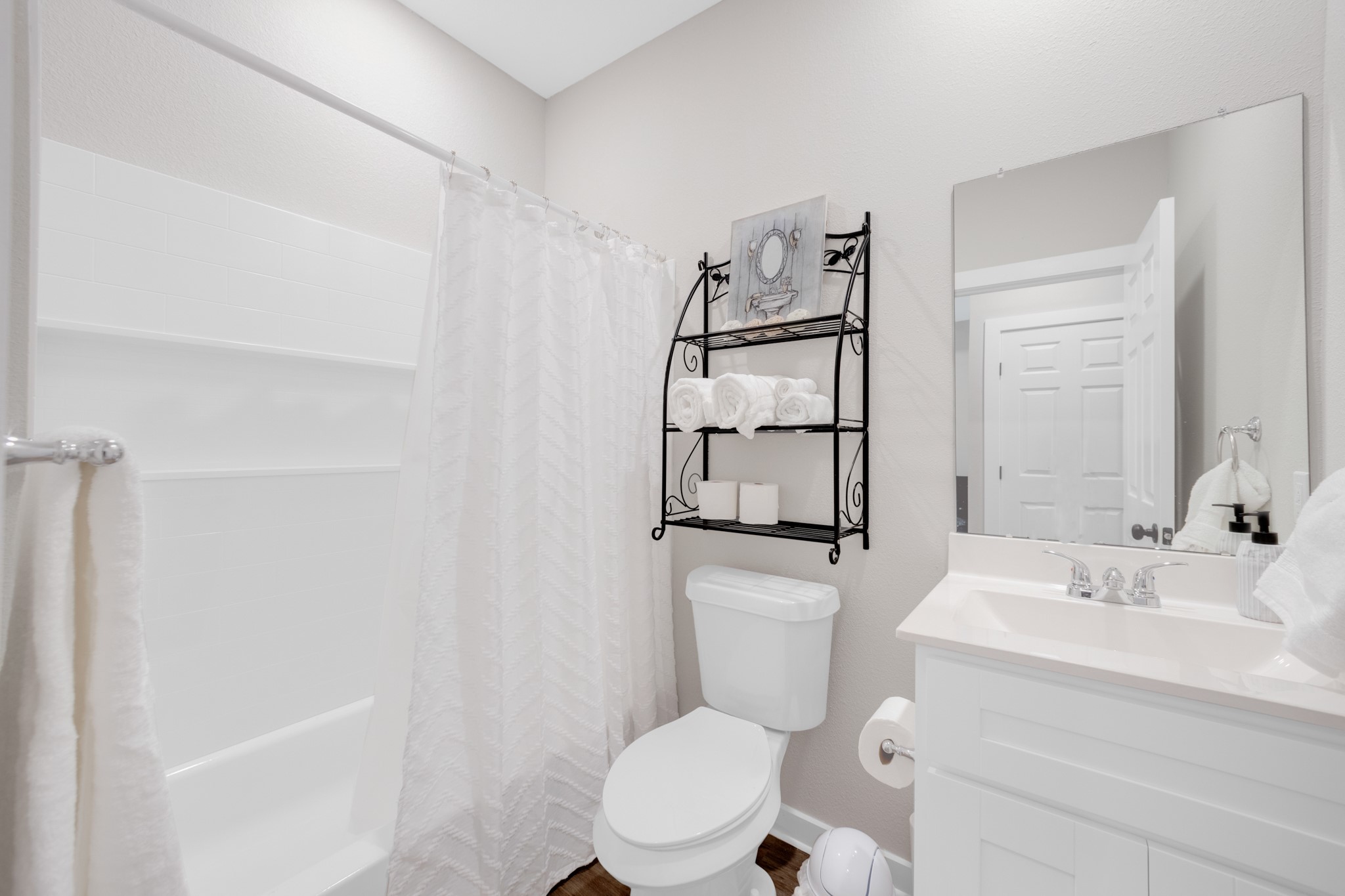 10317 Lake Road, Unit 9A Houston, TX 77070 - Photo 15 of 19 a bathroom with a sink a toilet and shower