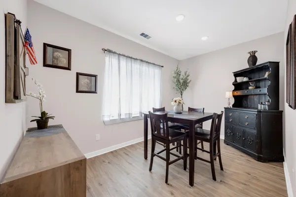 a view of a dining room with furniture and wooden floor