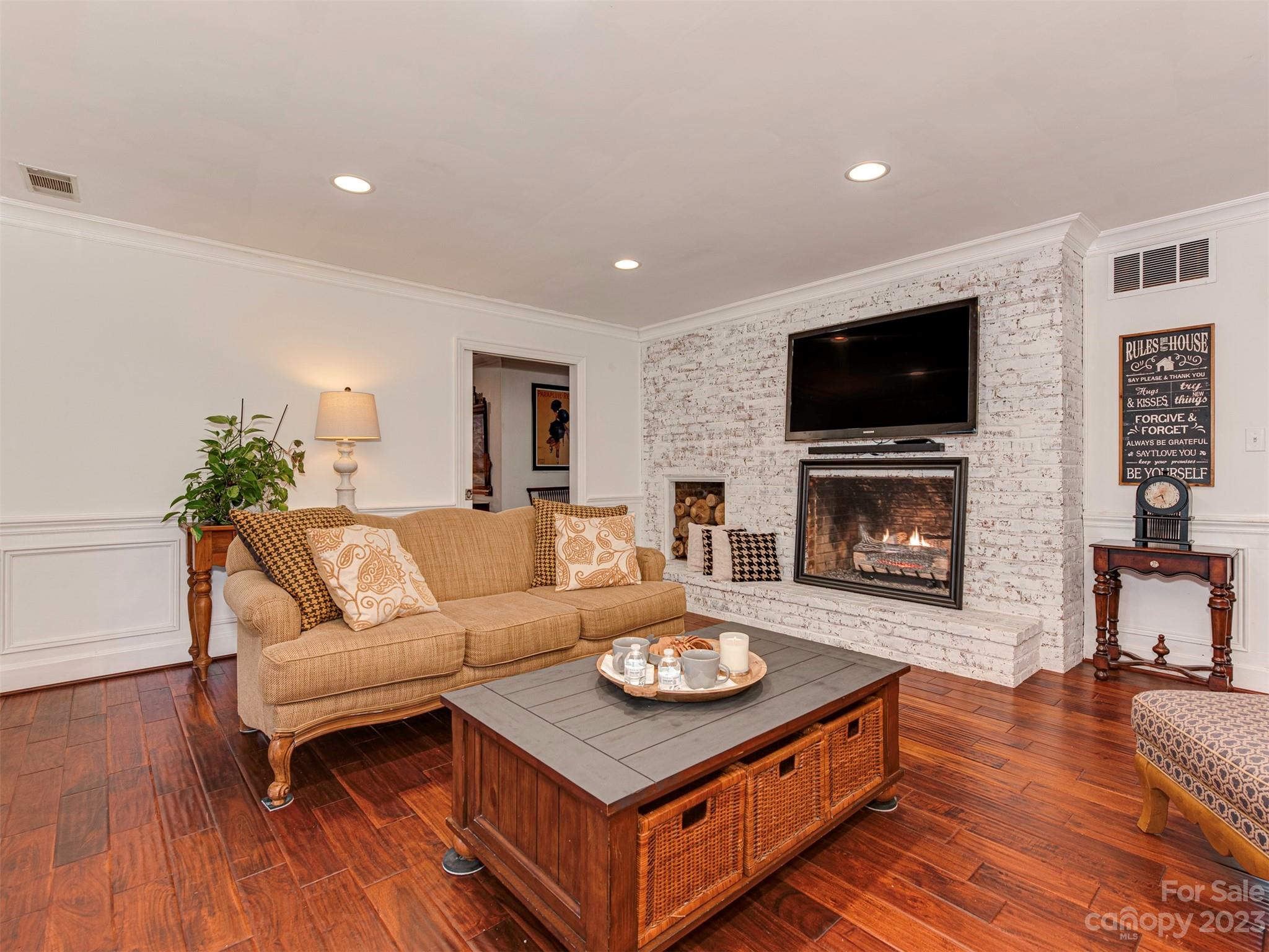 3101 High Ridge Road Charlotte, NC 28270 - Photo 17 of 45 a living room with furniture a flat screen tv and a fireplace