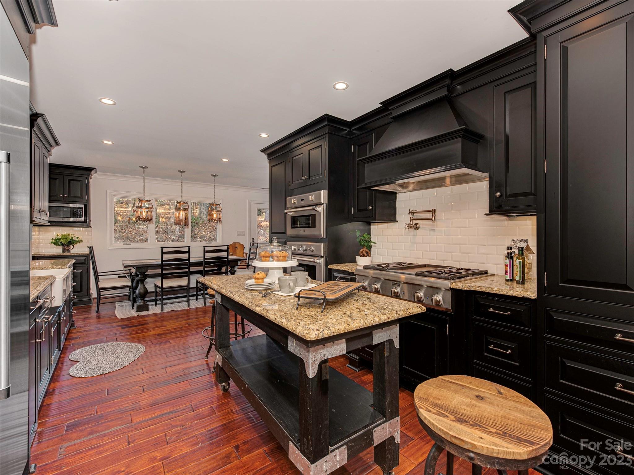 3101 High Ridge Road Charlotte, NC 28270 - Photo 6 of 45 a kitchen with a sink stove and wooden floor