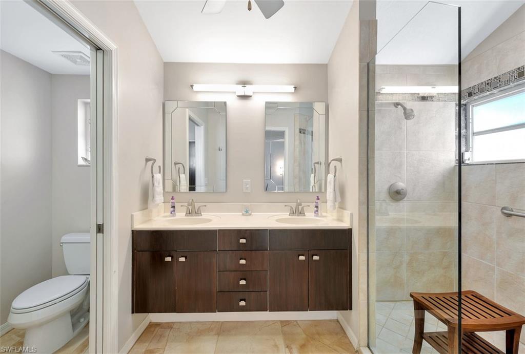159 San Rafael Lane Naples, FL 34119 - Photo 11 of 20 a bathroom with a granite countertop sink toilet and shower