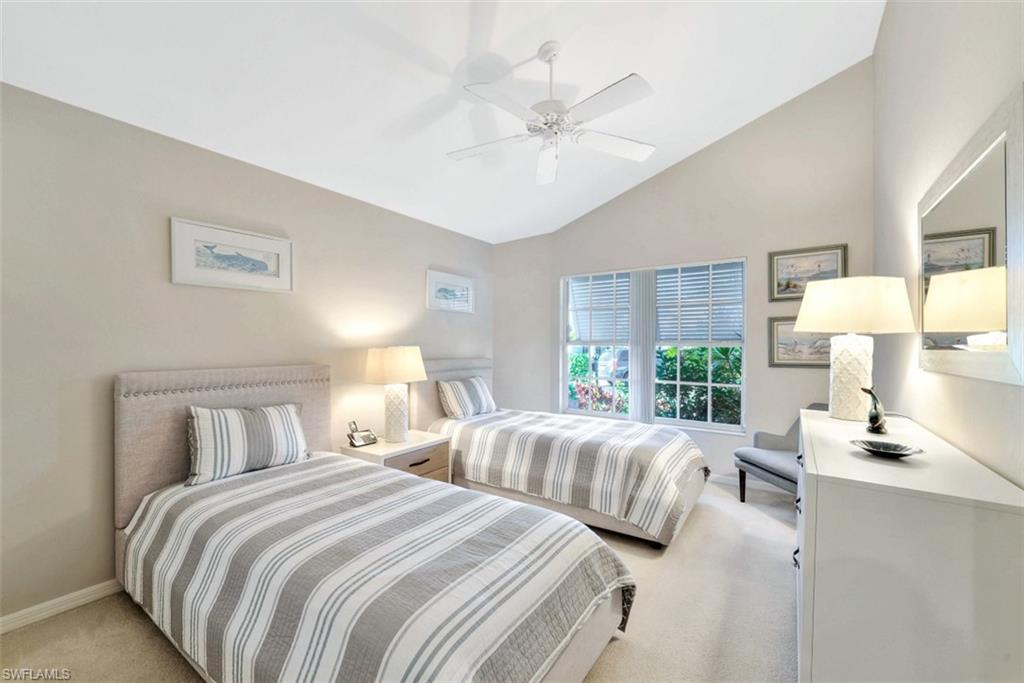 159 San Rafael Lane Naples, FL 34119 - Photo 12 of 20 a bedroom with two beds and a large window