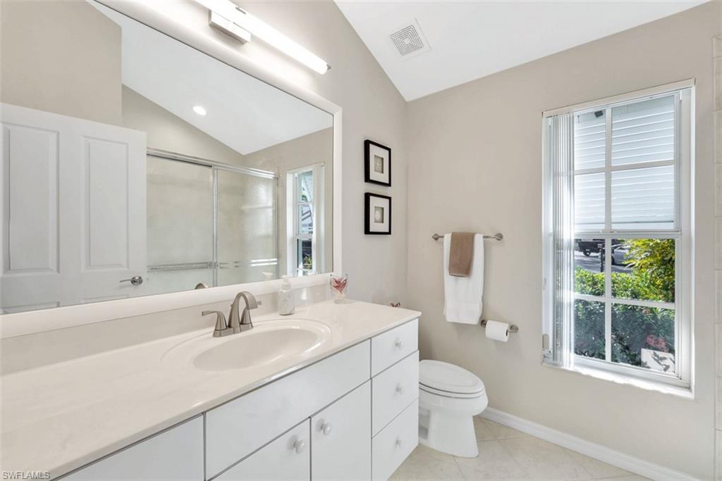 159 San Rafael Lane Naples, FL 34119 - Photo 13 of 20 a bathroom with a toilet a sink and large mirror