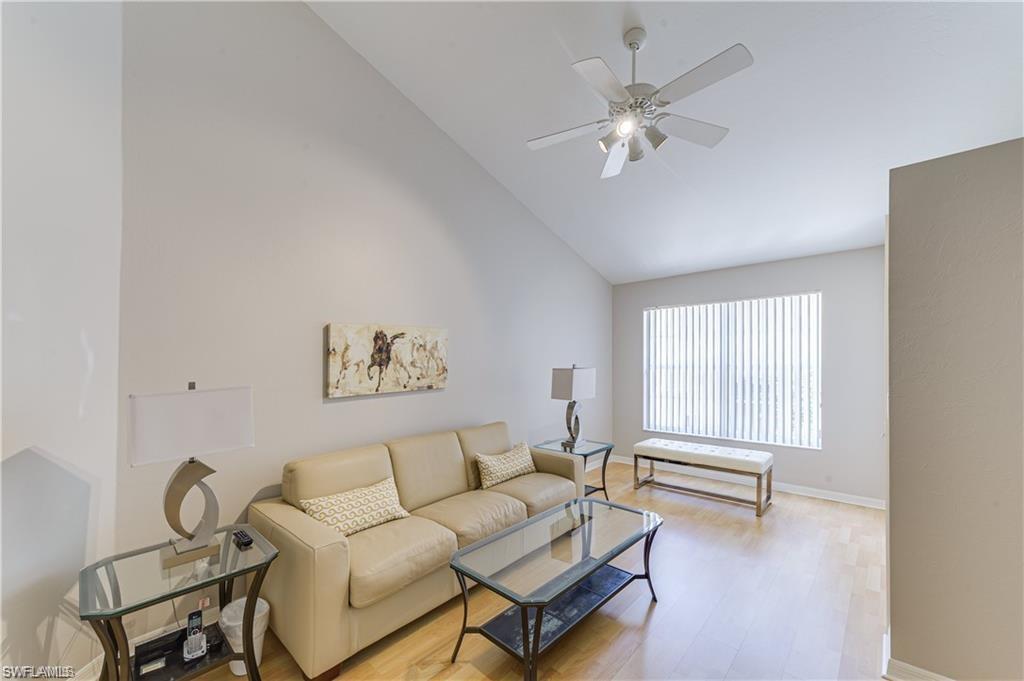 159 San Rafael Lane Naples, FL 34119 - Photo 14 of 20 a living room with furniture and a large window