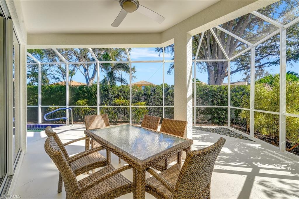 159 San Rafael Lane Naples, FL 34119 - Photo 15 of 20 a view of a patio with a table chairs and wooden fence