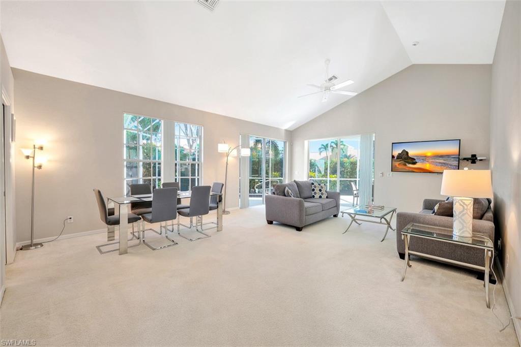 159 San Rafael Lane Naples, FL 34119 - Photo 3 of 20 a living room with furniture and large windows