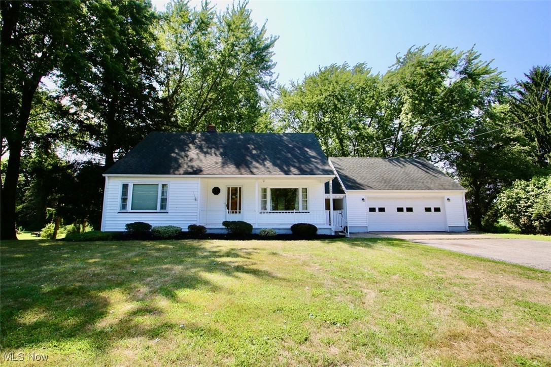 2802 South Ridge Road East Kingsville, OH 44048 - Photo 1 of 42 View of front of home with an attached garage, asphalt driveway, a front lawn, and view of scattered trees