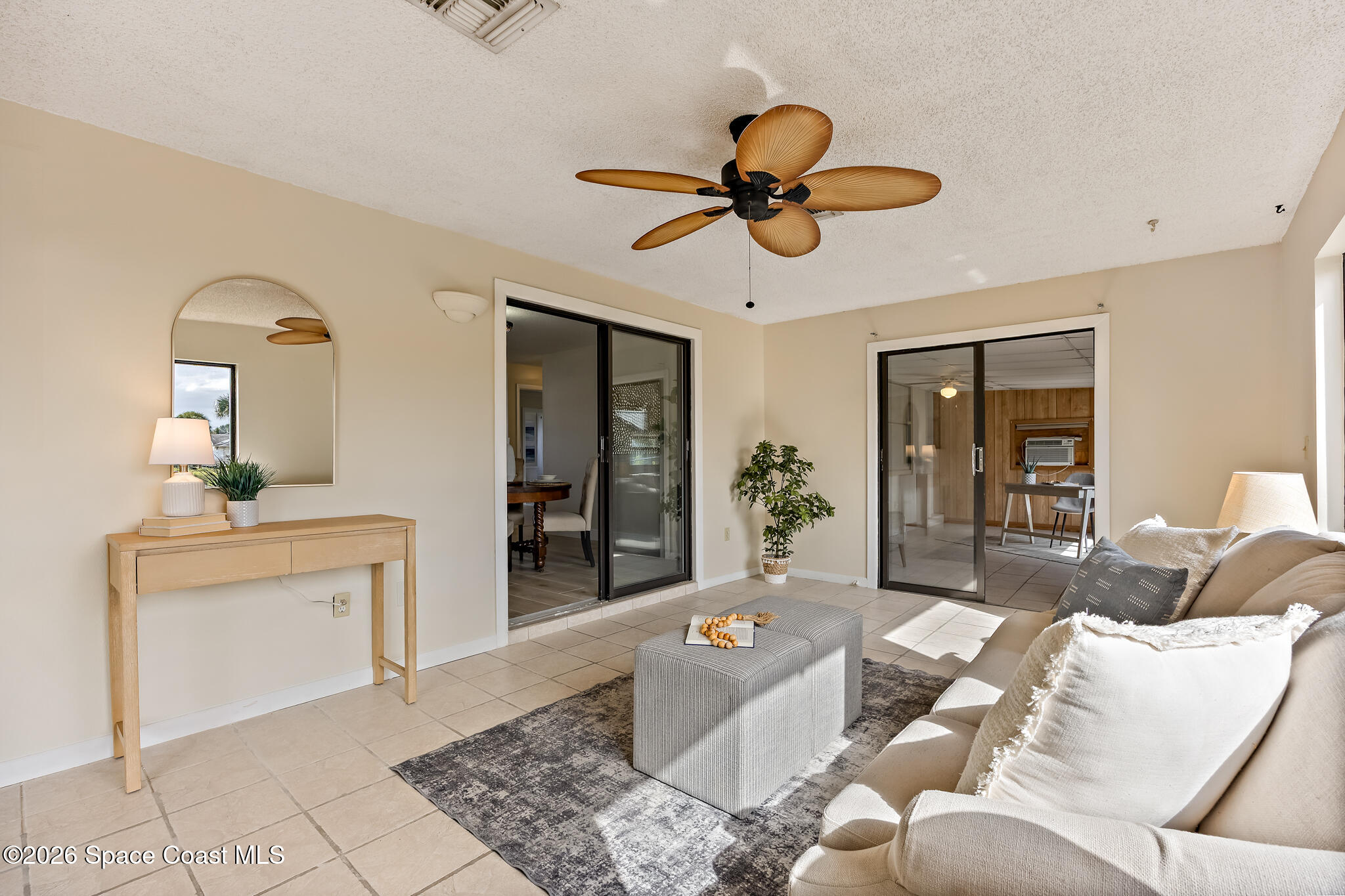 180 Concha Drive Sebastian, FL 32958 - Photo 14 of 32 a living room with furniture and a chandelier