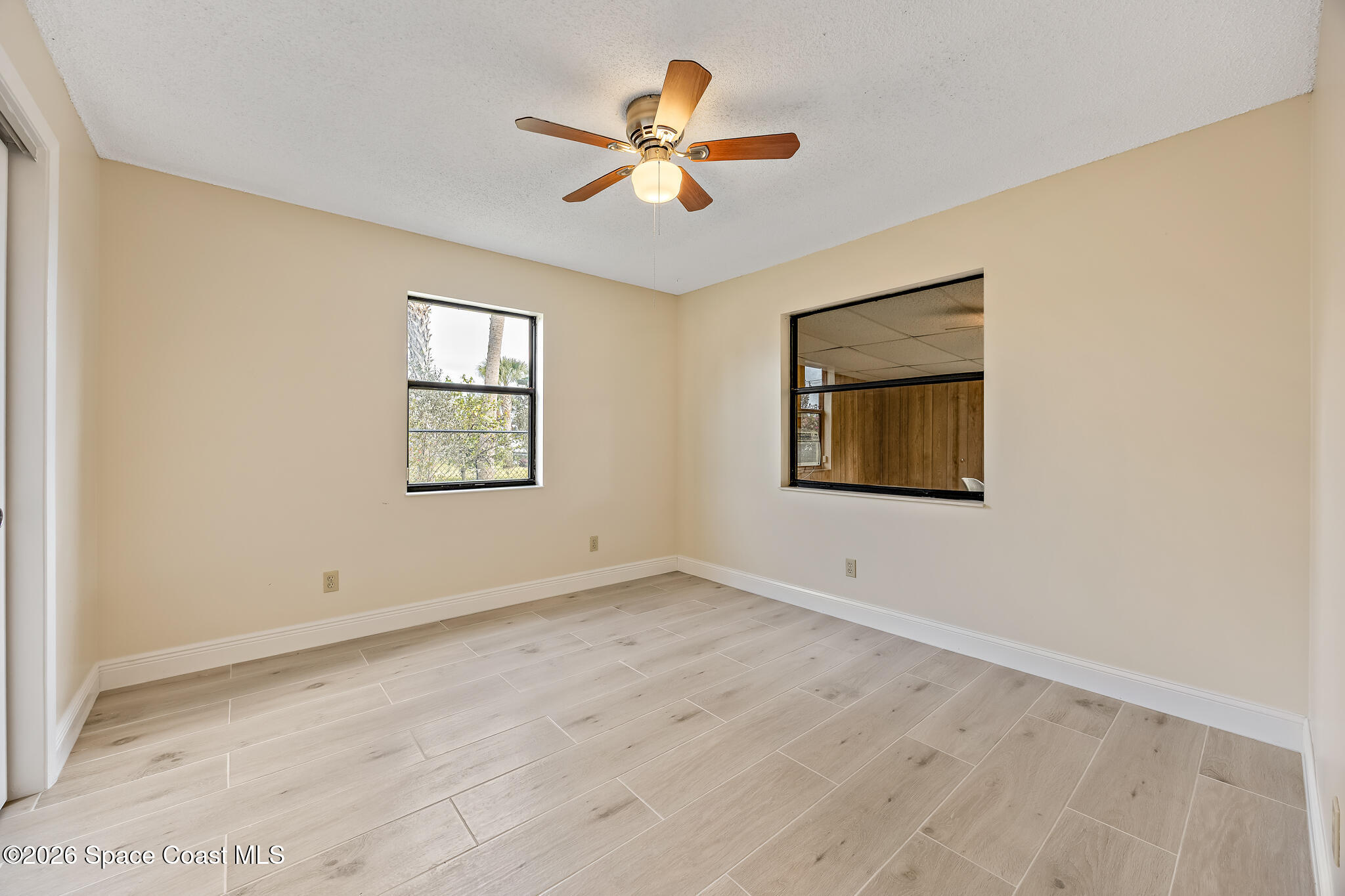 180 Concha Drive Sebastian, FL 32958 - Photo 19 of 32 an empty room with ceiling fan and window