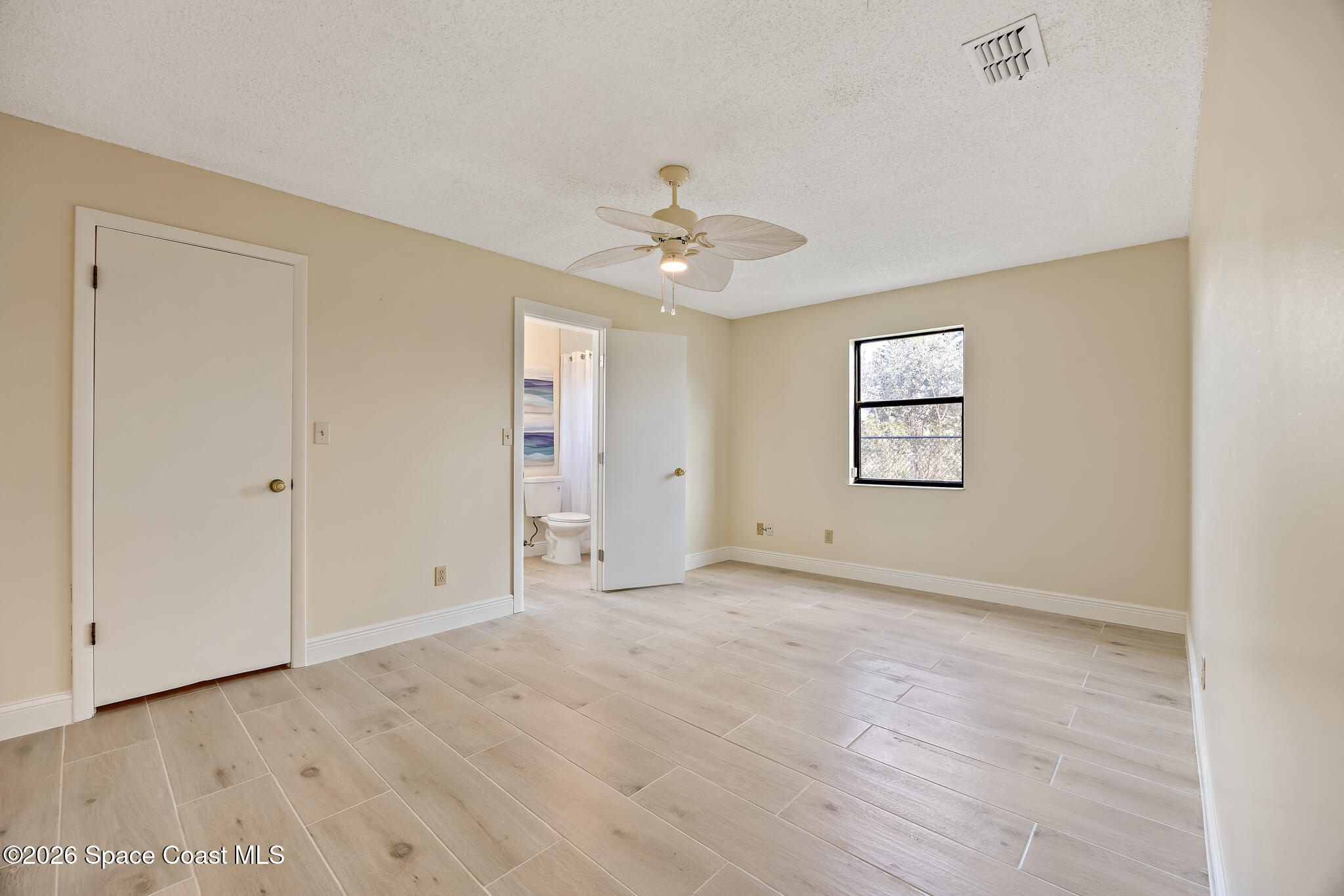 180 Concha Drive Sebastian, FL 32958 - Photo 22 of 32 an empty room with windows and ceiling fan