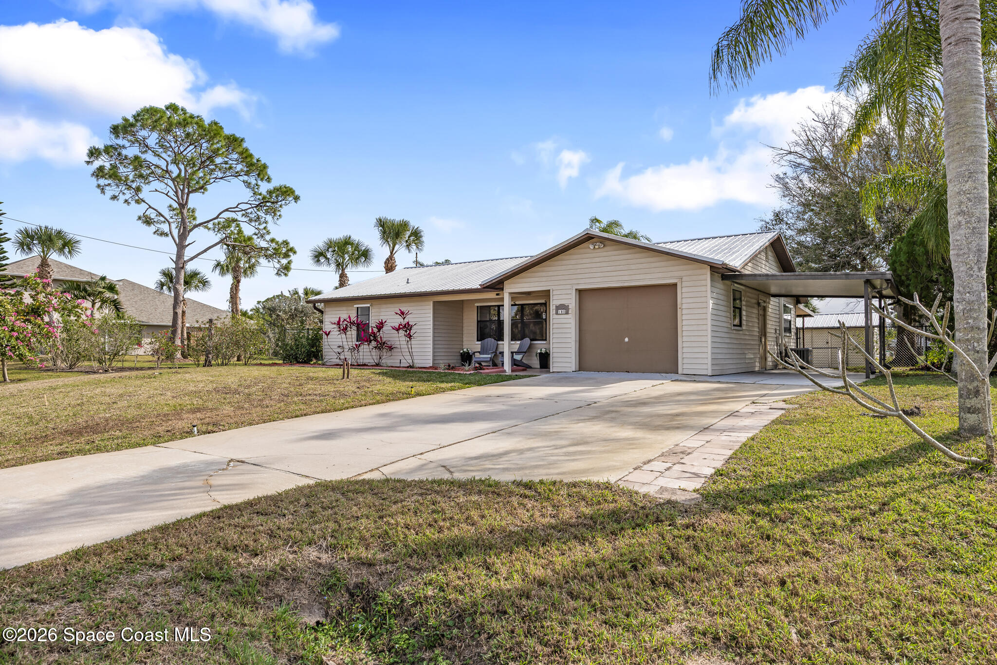 180 Concha Drive Sebastian, FL 32958 - Photo 32 of 32 a front view of a house with a yard and garage