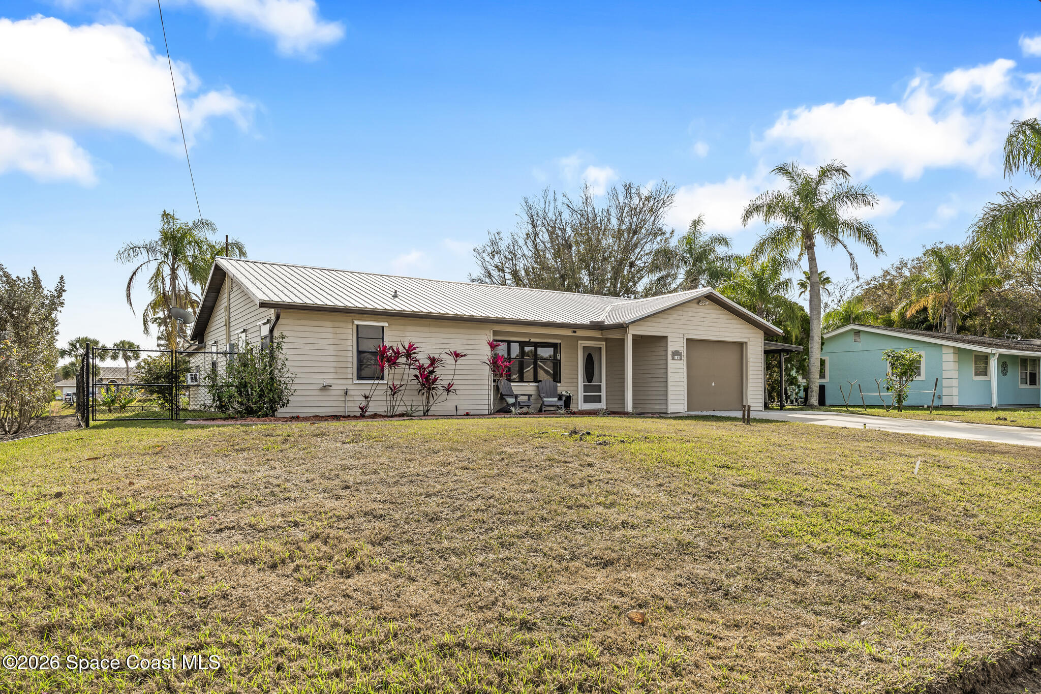 180 Concha Drive Sebastian, FL 32958 - Photo 5 of 32 a front view of a house with a yard and trees