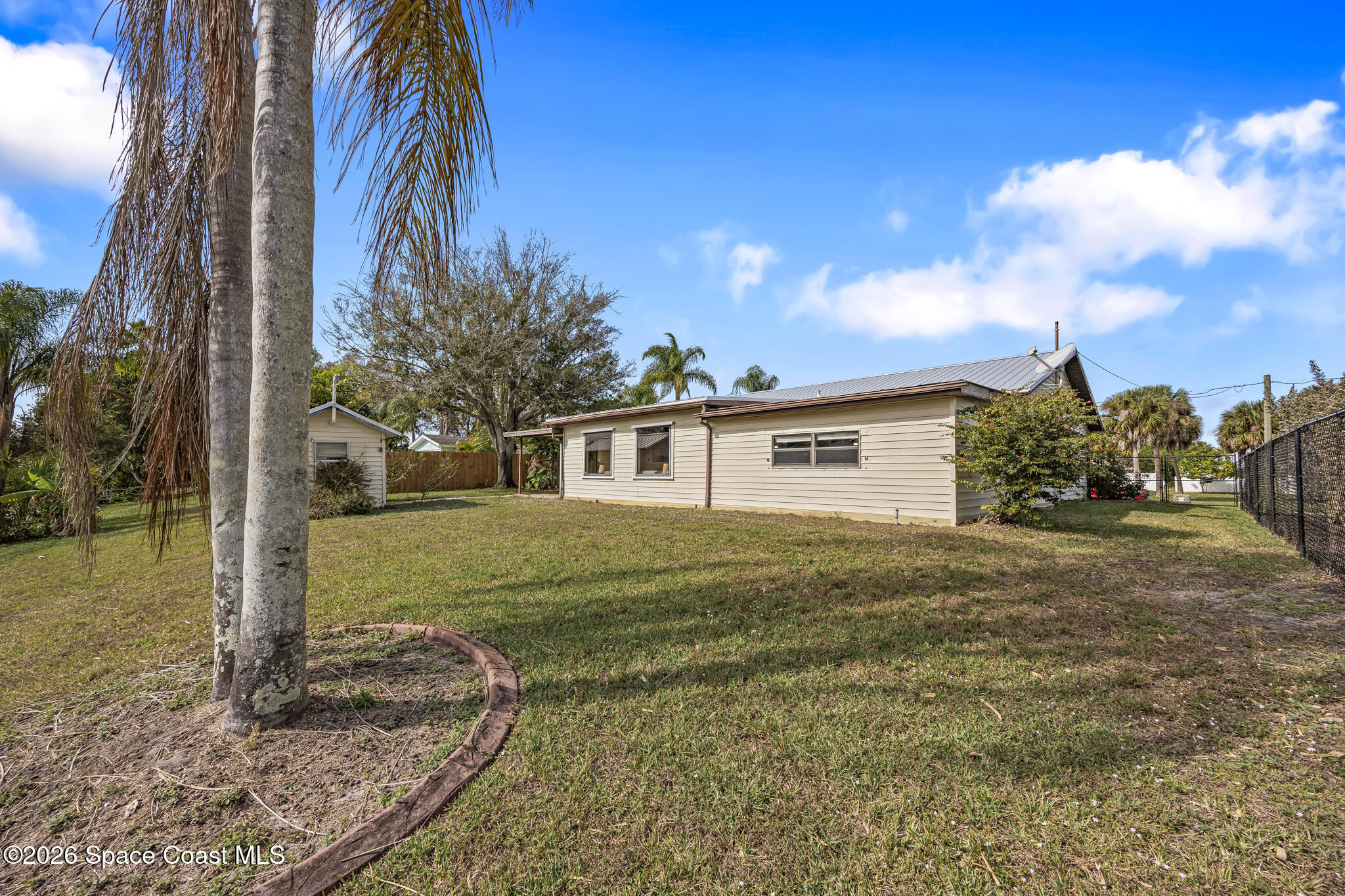 180 Concha Drive Sebastian, FL 32958 - Photo 6 of 32 a view of a yard in front of a house with a large tree
