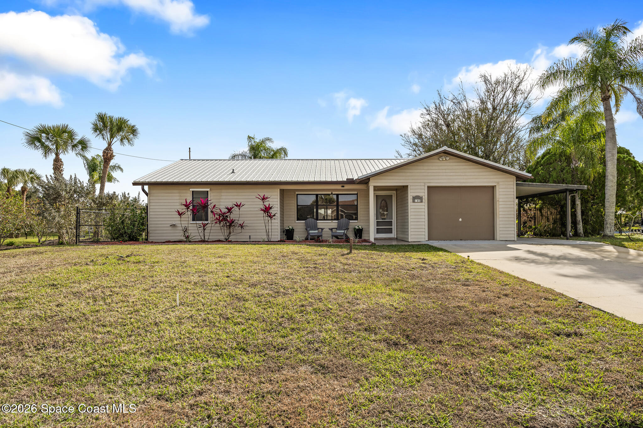 180 Concha Drive Sebastian, FL 32958 - Photo 7 of 32 a front view of a house with a garden