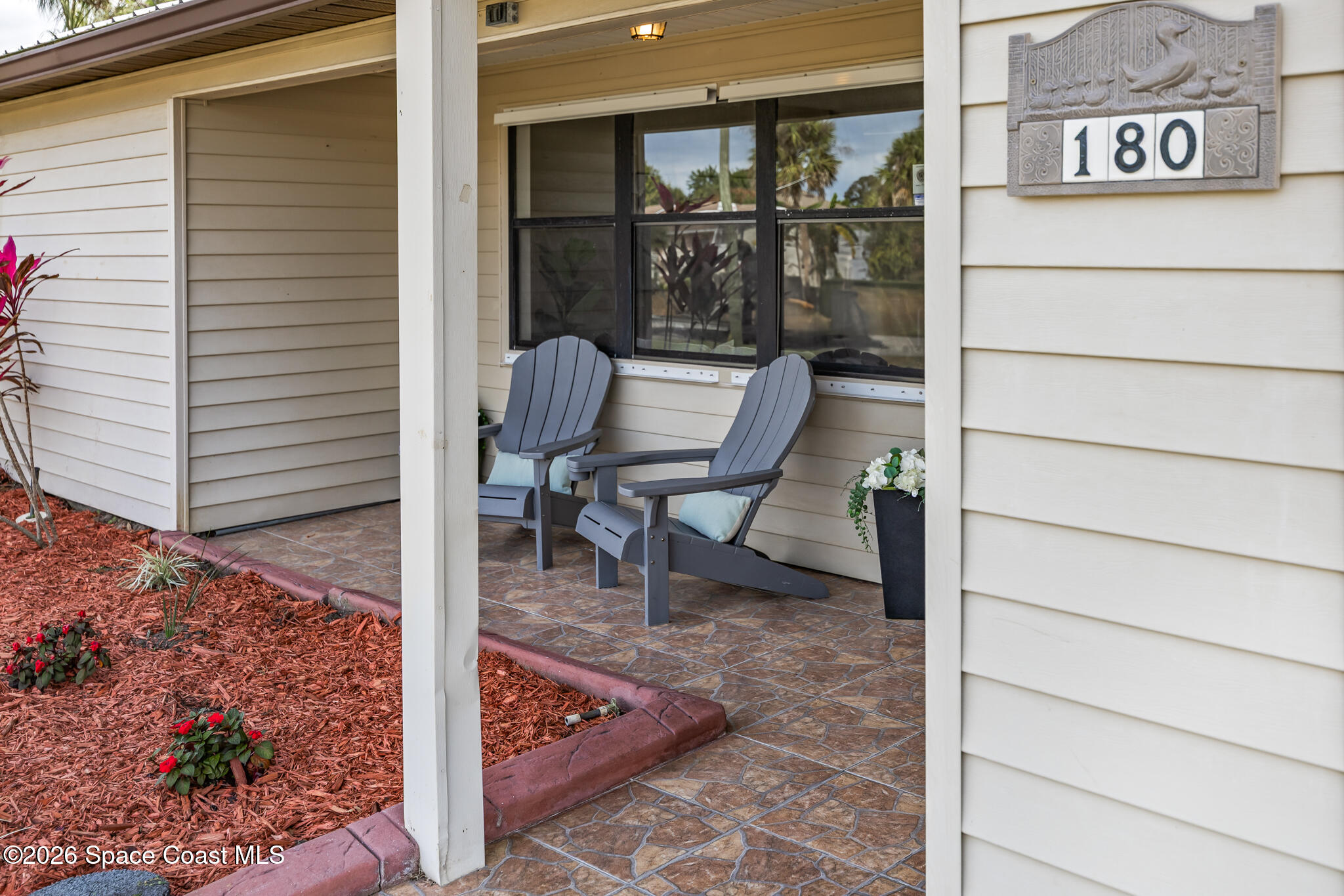 180 Concha Drive Sebastian, FL 32958 - Photo 9 of 32 a view of porch with a bench and a potted plant