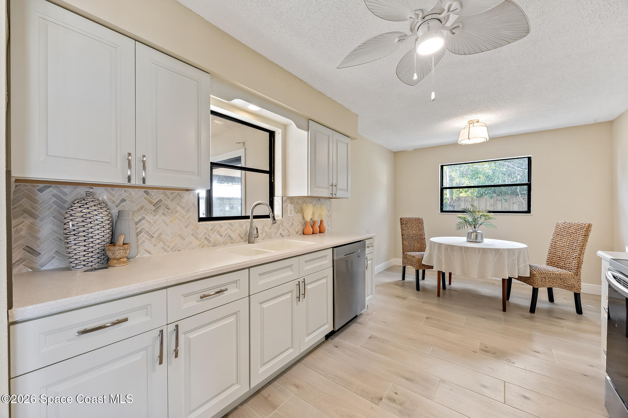 180 Concha Drive Sebastian, FL 32958 - Photo 10 of 32 a living room with granite countertop furniture a window and a flat screen tv