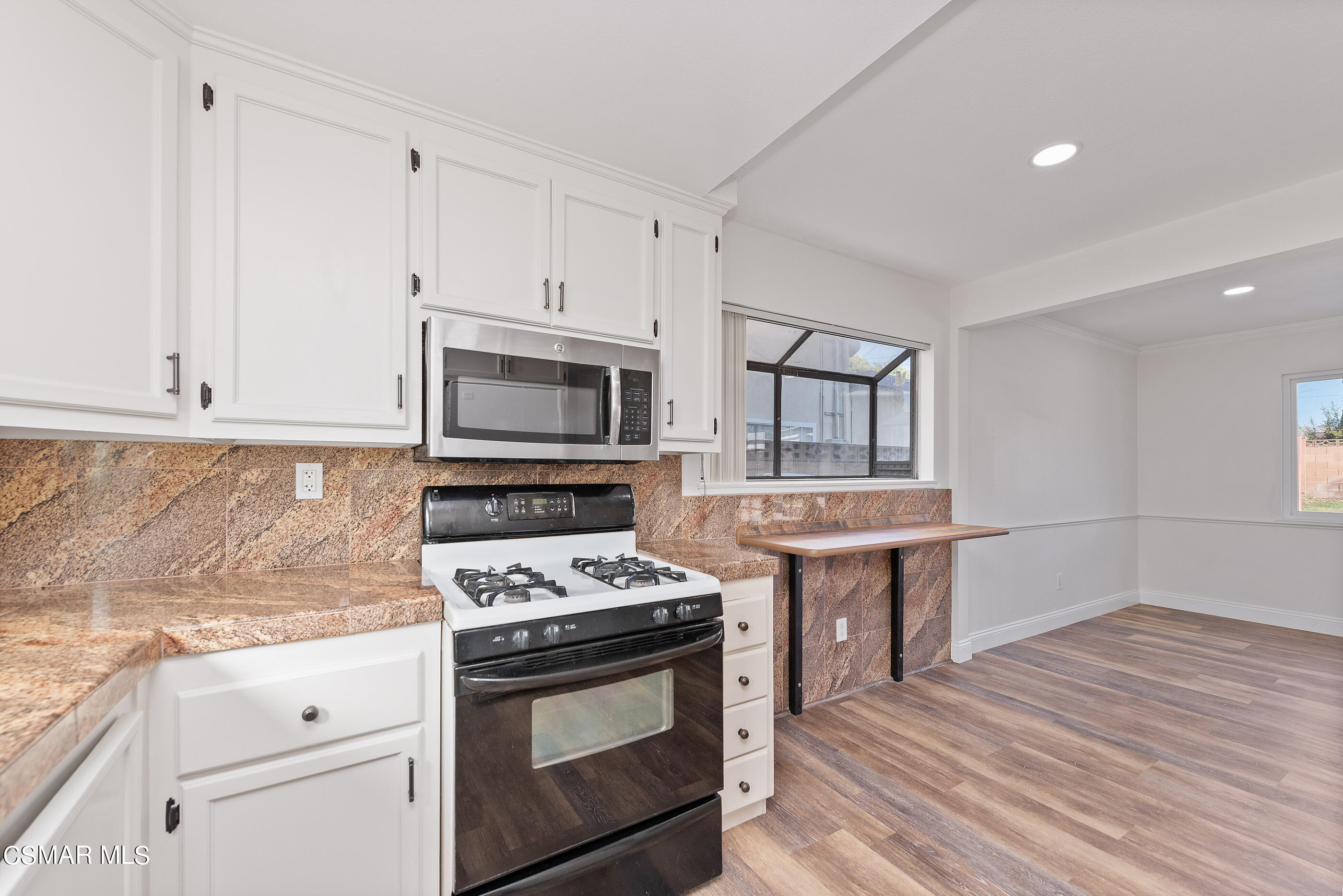 2181 Rhoda Street Simi Valley, CA 93065 - Photo 13 of 36 a kitchen with stainless steel appliances a stove microwave and cabinets