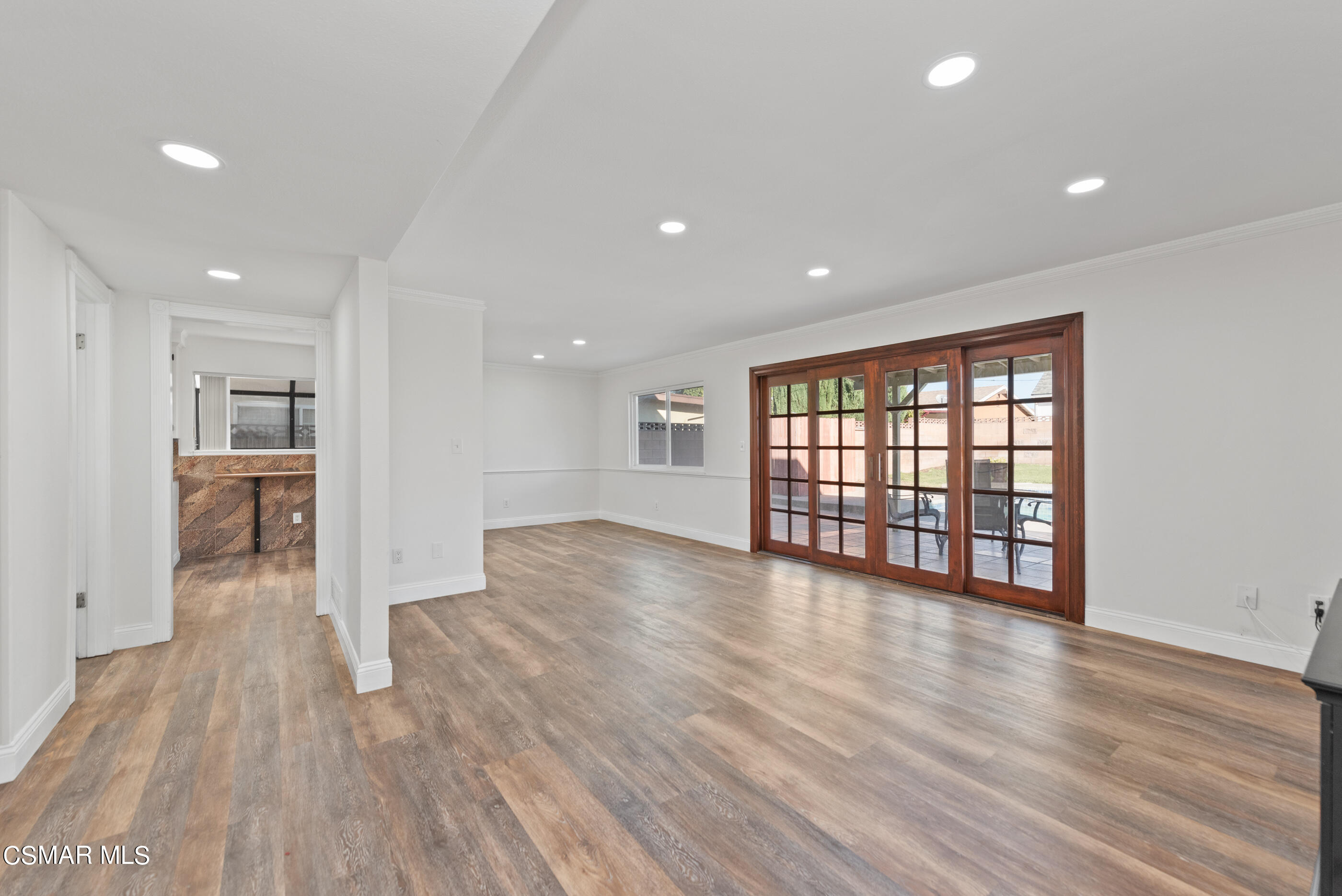 2181 Rhoda Street Simi Valley, CA 93065 - Photo 4 of 36 a view of an empty room with wooden floor and a window