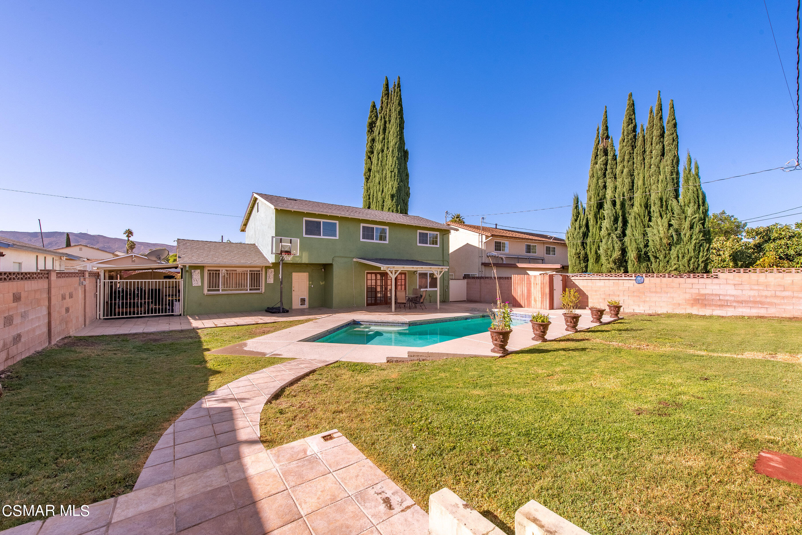 2181 Rhoda Street Simi Valley, CA 93065 - Photo 34 of 36 a view of a swimming pool with a lawn chairs and a big yard