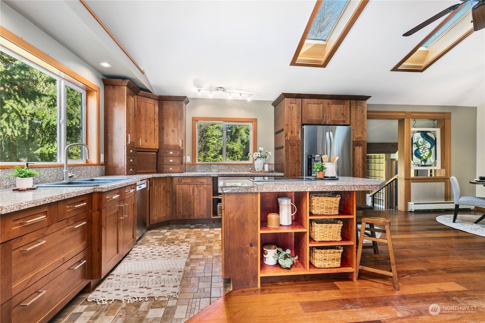 3193 Behme Road Custer, WA 98240 - Photo 4 of 33 a kitchen with stainless steel appliances kitchen island granite countertop wooden cabinets a dining table and chairs