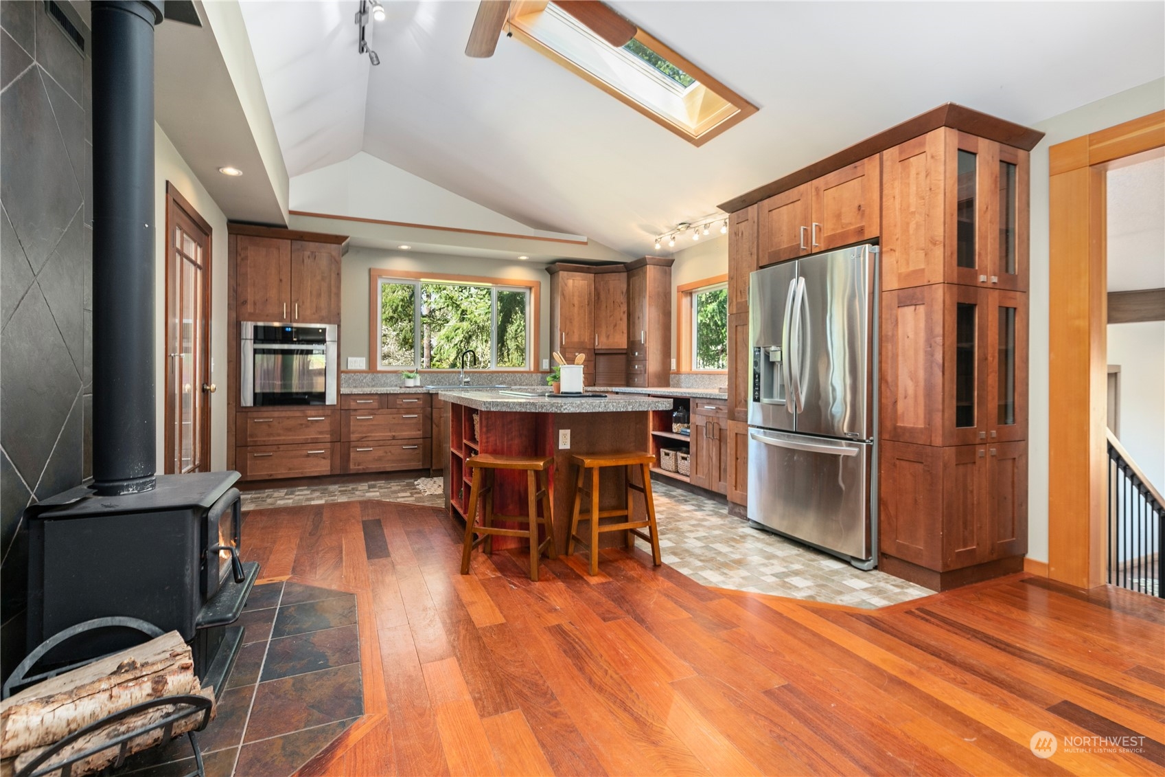 3193 Behme Road Custer, WA 98240 - Photo 7 of 33 a kitchen with stainless steel appliances wooden floor dining table and chairs