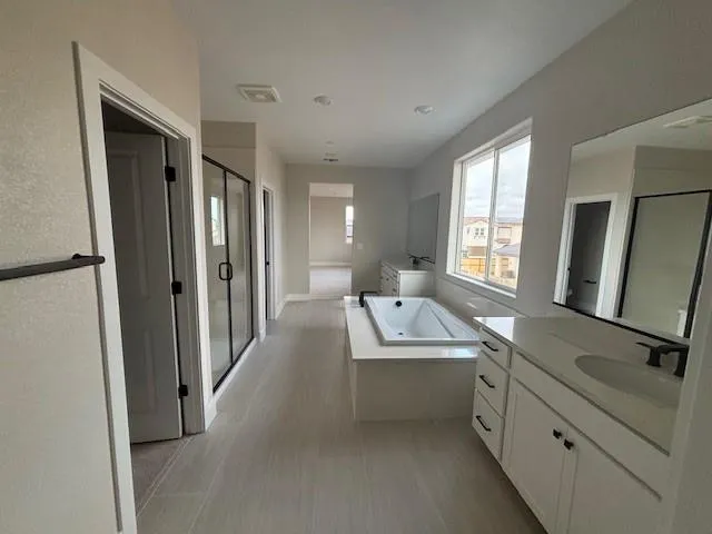 a hall with a sink a mirror and a shower