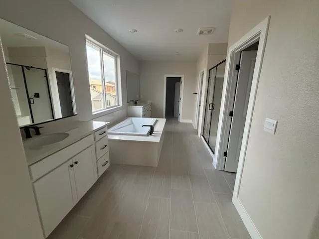 a bathroom with a sink a mirror and a bathtub