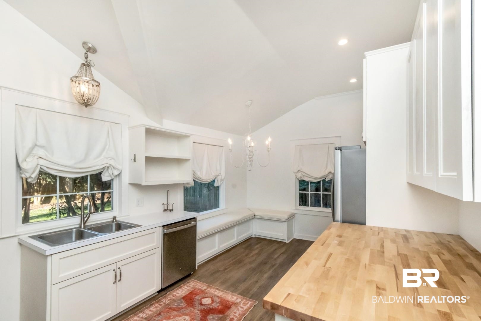 16 Princess Anne Road Mobile, AL 36608 - Photo 7 of 40 Kitchen with white cabinets, decorative light fixtures, a chandelier, vaulted ceiling, and dark wood-style floors