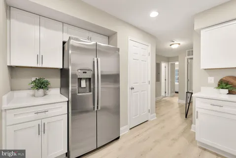 a kitchen with a refrigerator sink and cabinets