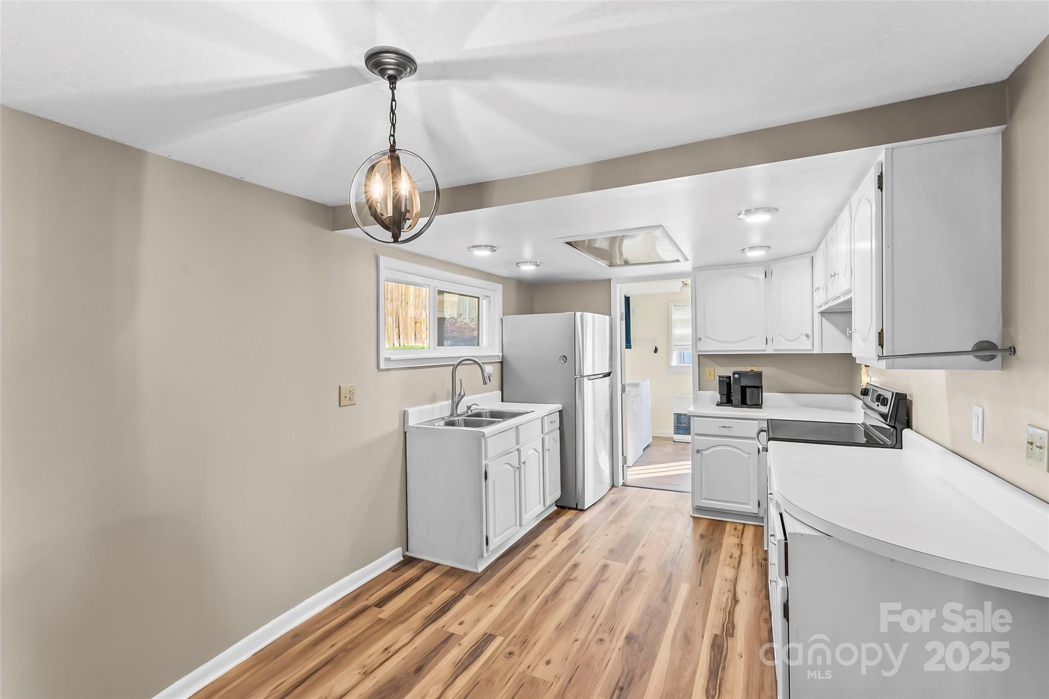 70 1st Street Canton, NC 28716 - Photo 12 of 34 a kitchen with stainless steel appliances granite countertop a sink stove and refrigerator
