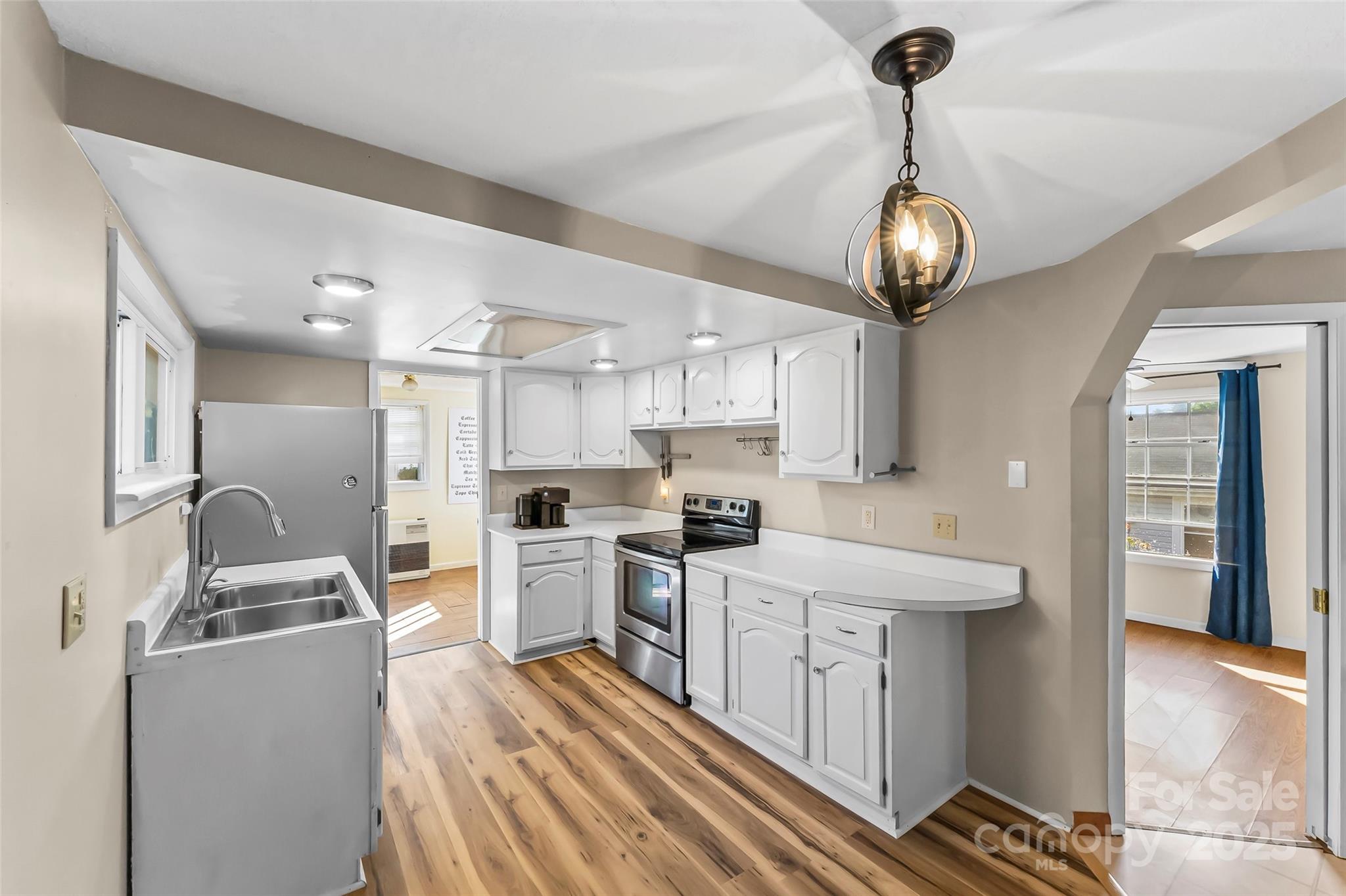 70 1st Street Canton, NC 28716 - Photo 13 of 34 a kitchen with stainless steel appliances kitchen island granite countertop a sink and refrigerator