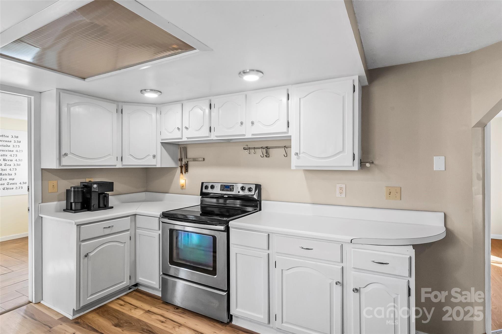 70 1st Street Canton, NC 28716 - Photo 14 of 34 a kitchen with granite countertop white cabinets and white appliances