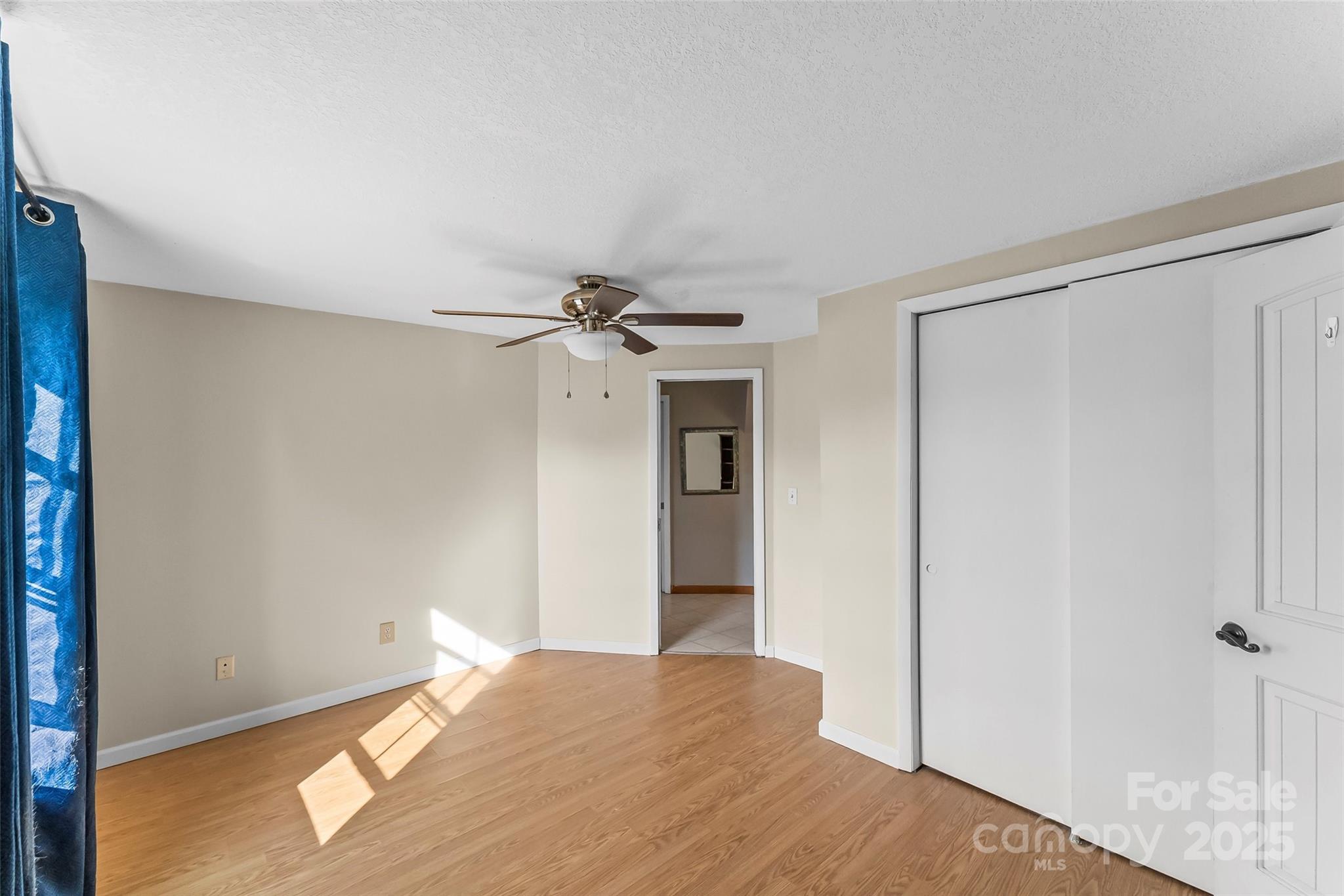 70 1st Street Canton, NC 28716 - Photo 18 of 34 a view of empty room with wooden floor and fan