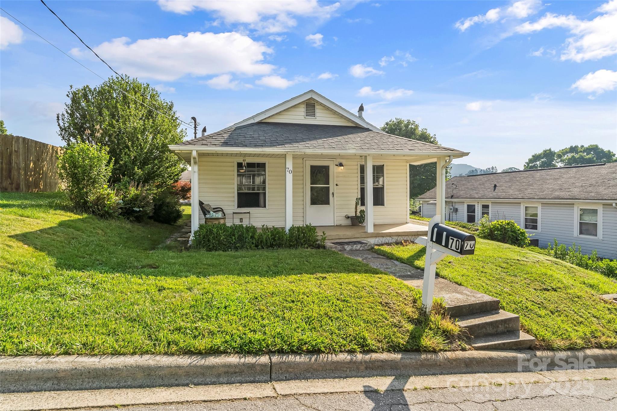 70 1st Street Canton, NC 28716 - Photo 2 of 34 a front view of a house with garden