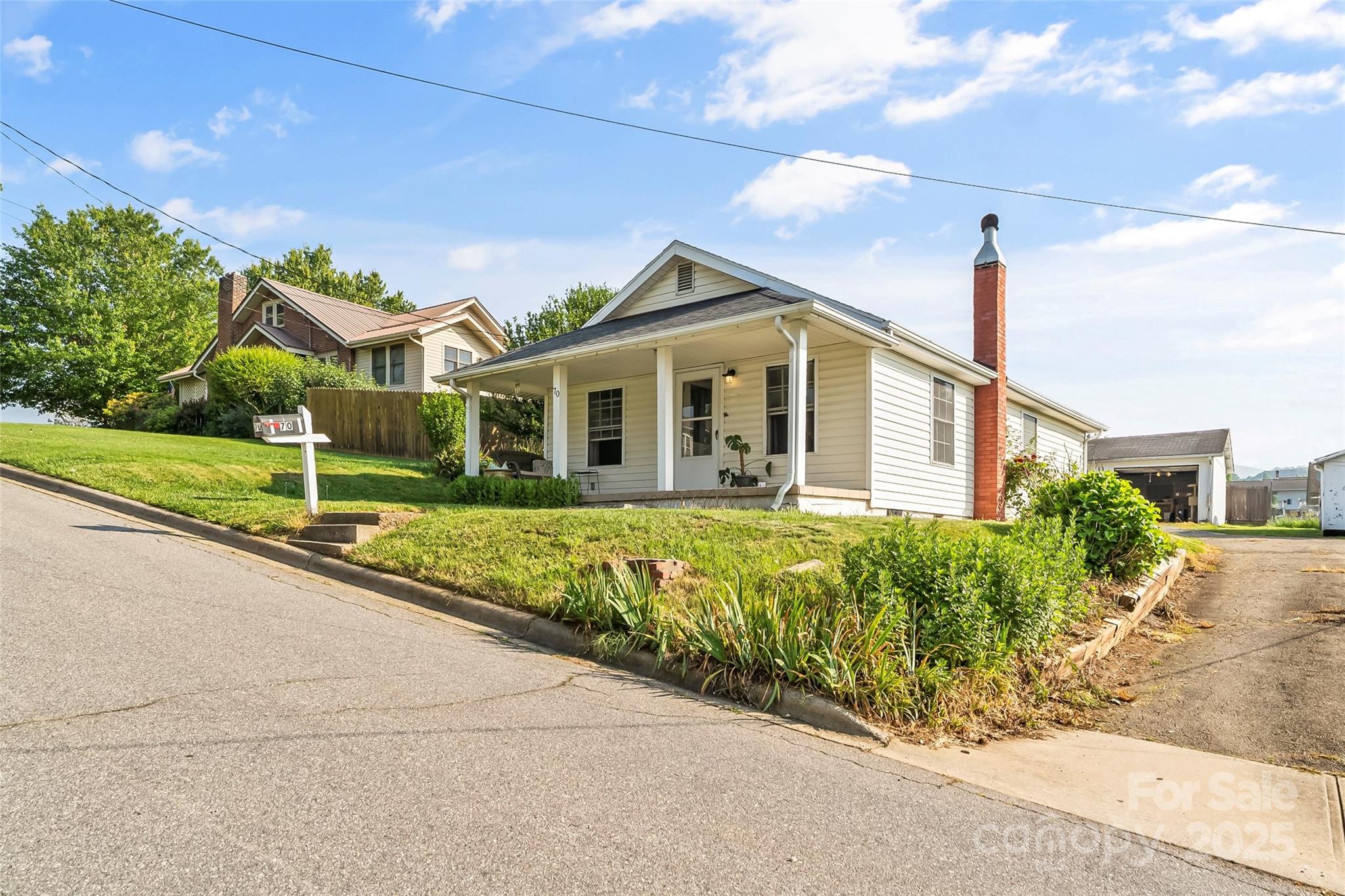 70 1st Street Canton, NC 28716 - Photo 4 of 34 a front view of a house with a garden