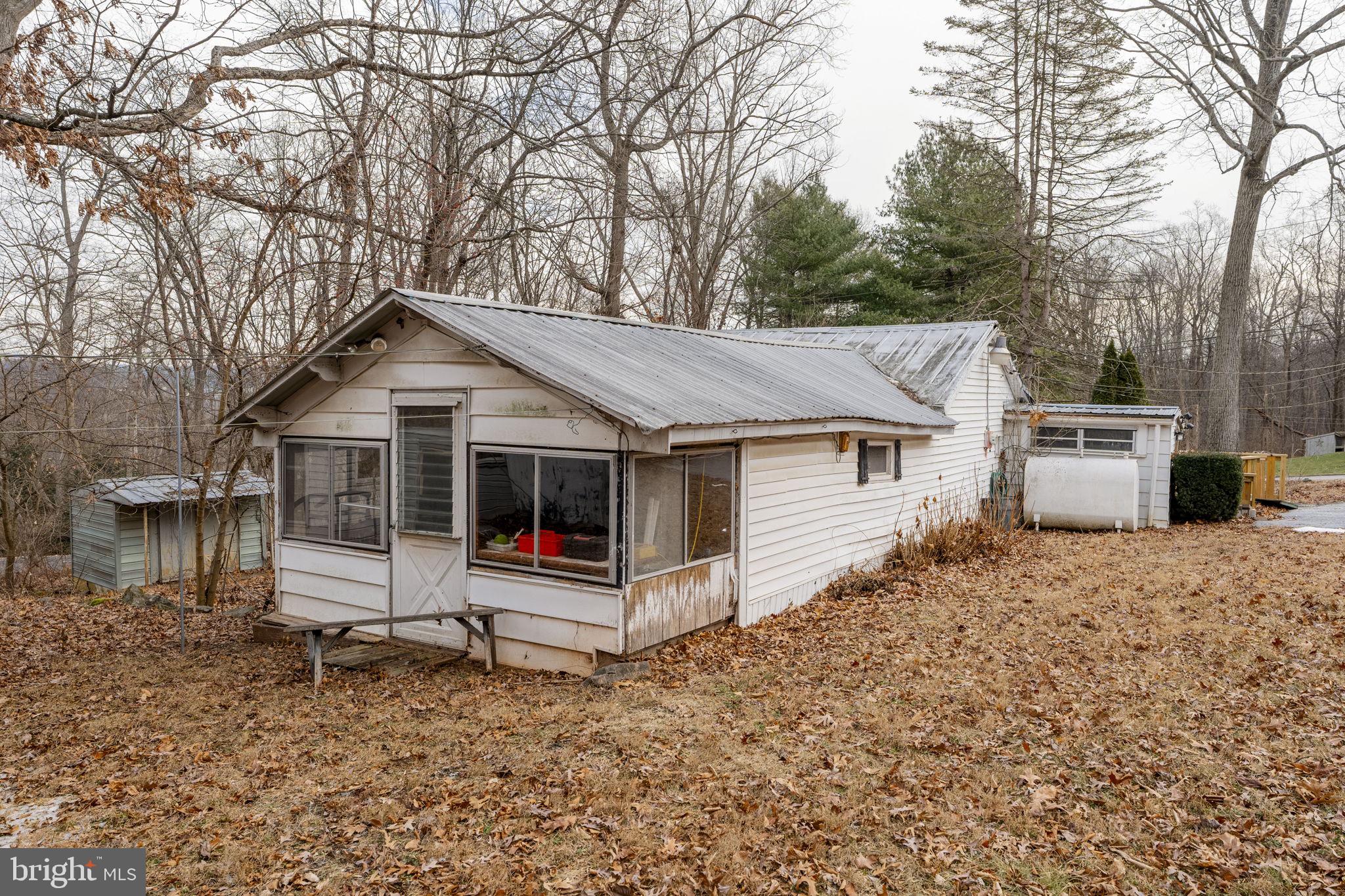 105 Wollups Hill Road Denver, PA 17517 - Photo 9 of 14 a front view of a house with a yard and large tree