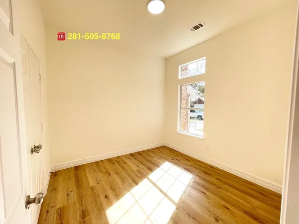 a view of a livingroom with wooden floor and a window