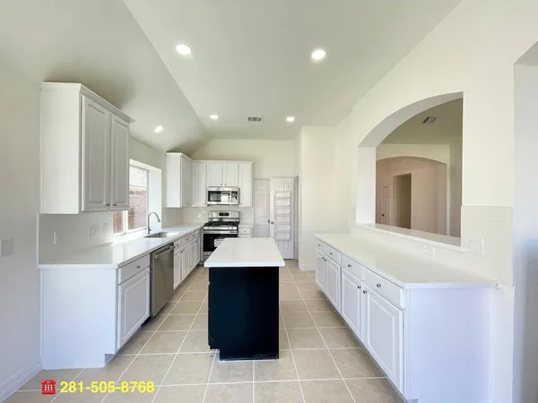 a view of a room with wooden floor and white walls