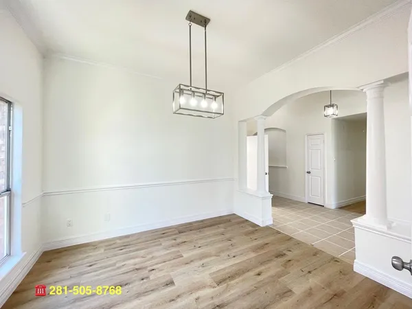 a large white kitchen with a stove a sink dishwasher and a refrigerator