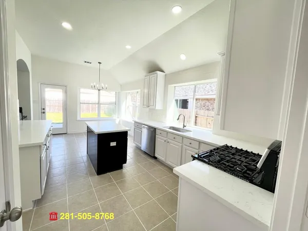 a kitchen with a sink stove and cabinets
