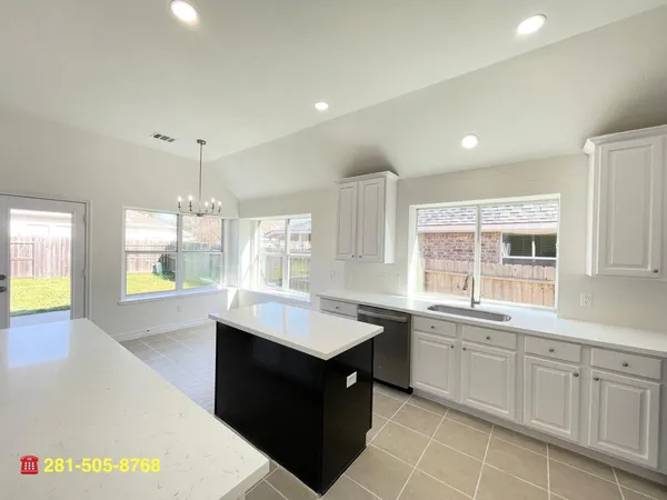 a view of a kitchen and kitchen island