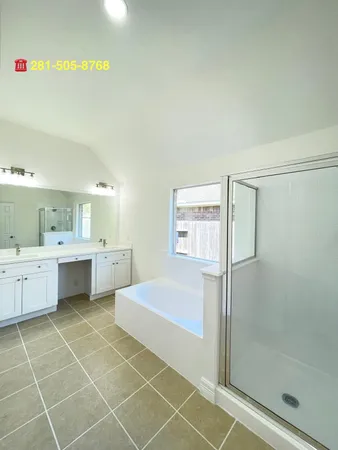 a large white room with a double vanity sink and a mirror
