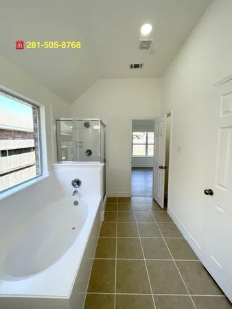a bathroom with a bathtub and a shower