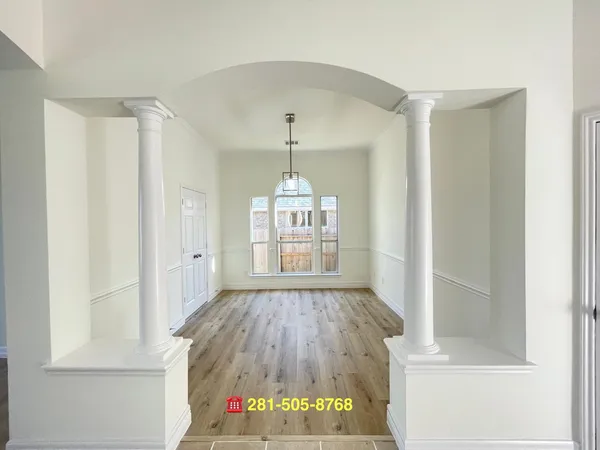 a very nice looking room with a window and a chandelier