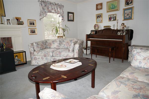 31 Robert Road Stow, MA 01775 - Photo 8 of 11 a living room with furniture and a fireplace