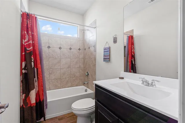 a bedroom with a bed and a lamp next to a window